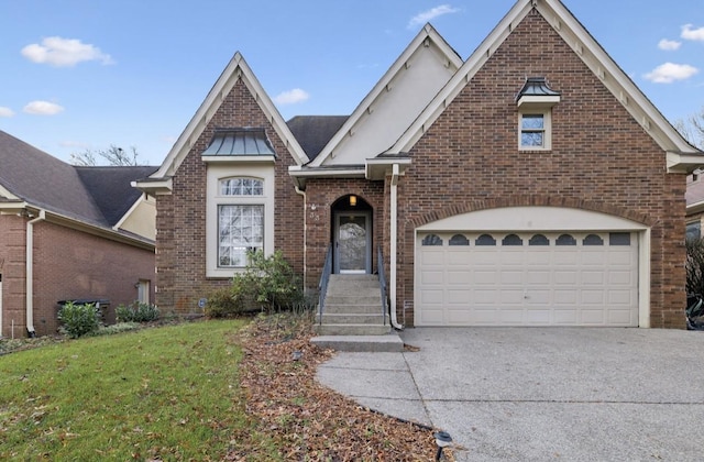 view of front of property with a front yard and a garage