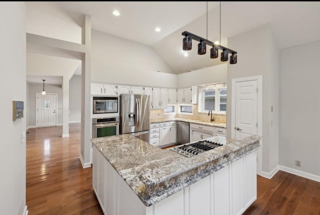 kitchen featuring white cabinetry, sink, dark wood-type flooring, light stone counters, and appliances with stainless steel finishes