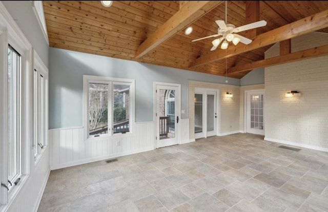 unfurnished sunroom with lofted ceiling with beams, ceiling fan, and wood ceiling