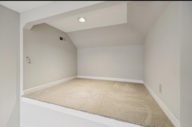 bonus room featuring carpet floors and vaulted ceiling