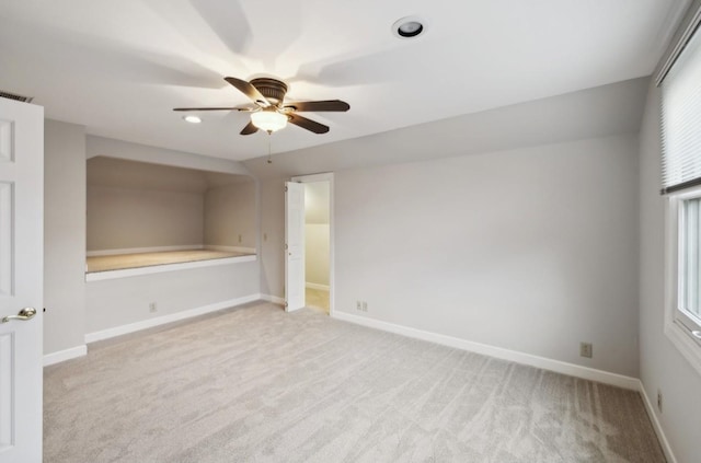 spare room featuring ceiling fan and light carpet