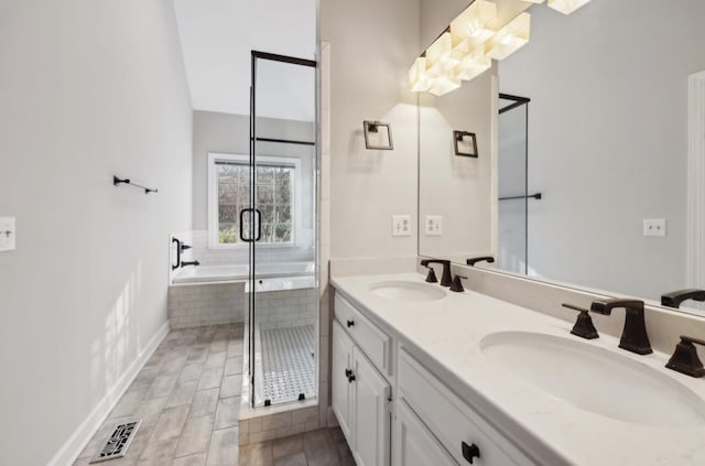 bathroom featuring hardwood / wood-style floors, vanity, and shower with separate bathtub