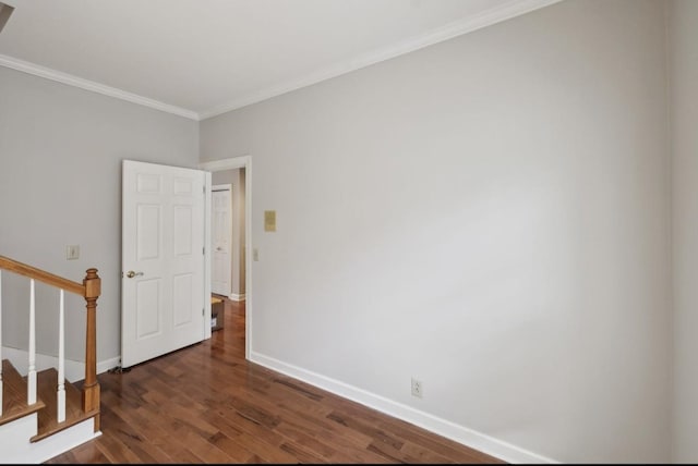 spare room with dark hardwood / wood-style flooring and ornamental molding