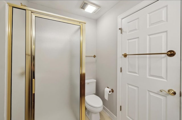 bathroom featuring toilet and a shower with shower door