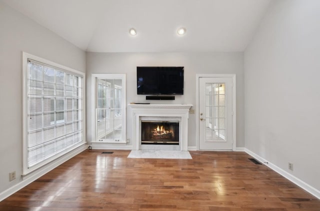 unfurnished living room with dark wood-type flooring and vaulted ceiling