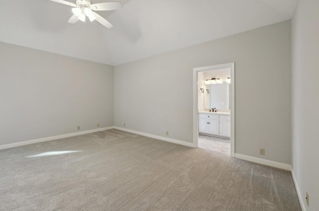 unfurnished bedroom featuring ceiling fan, sink, ensuite bathroom, and light carpet