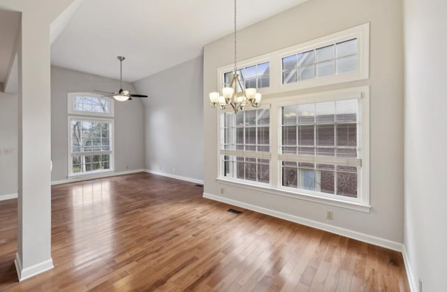 interior space featuring hardwood / wood-style floors and ceiling fan with notable chandelier