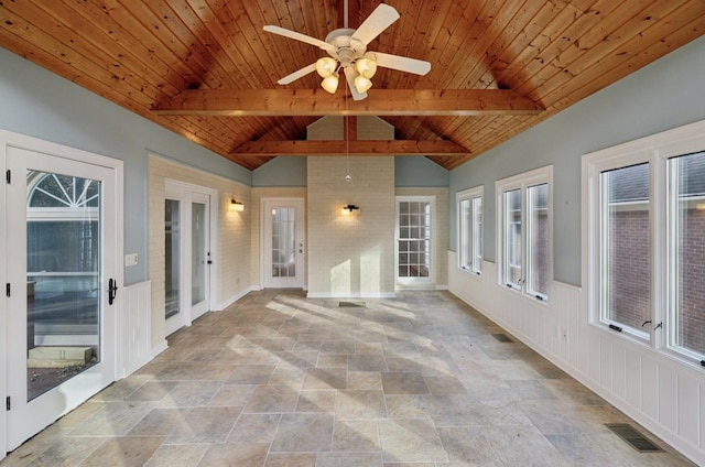 unfurnished sunroom featuring vaulted ceiling with beams, ceiling fan, french doors, and wooden ceiling