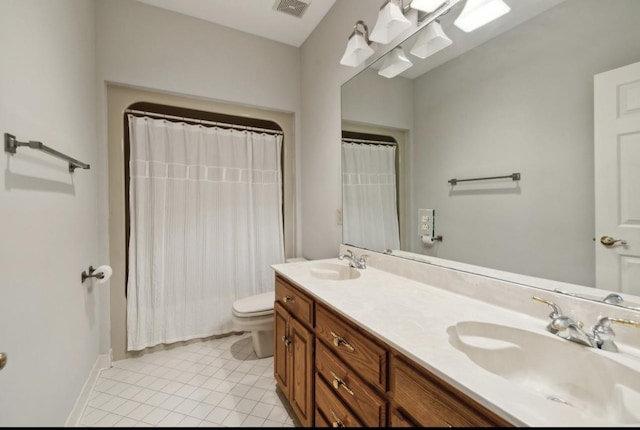 bathroom featuring toilet, vanity, and tile patterned floors