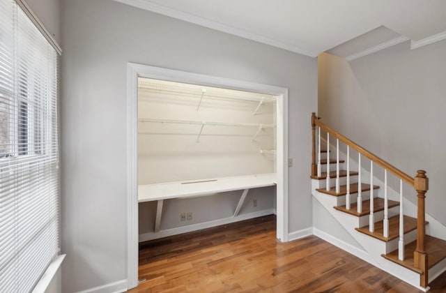 interior space with wood-type flooring and ornamental molding