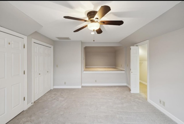 unfurnished bedroom featuring ceiling fan and light carpet