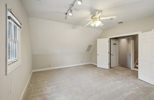 bonus room featuring ceiling fan, light colored carpet, and vaulted ceiling