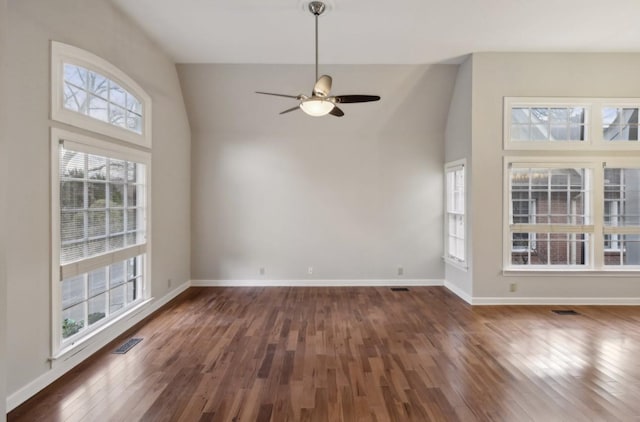 interior space with ceiling fan, dark wood-type flooring, and high vaulted ceiling