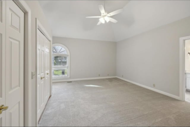 unfurnished bedroom featuring light carpet and ceiling fan