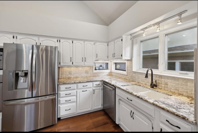 kitchen with white cabinetry, dark hardwood / wood-style floors, vaulted ceiling, and appliances with stainless steel finishes