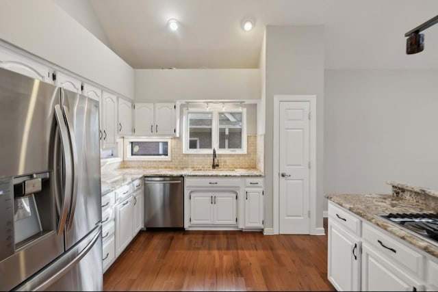 kitchen with dark hardwood / wood-style flooring, sink, white cabinets, and appliances with stainless steel finishes