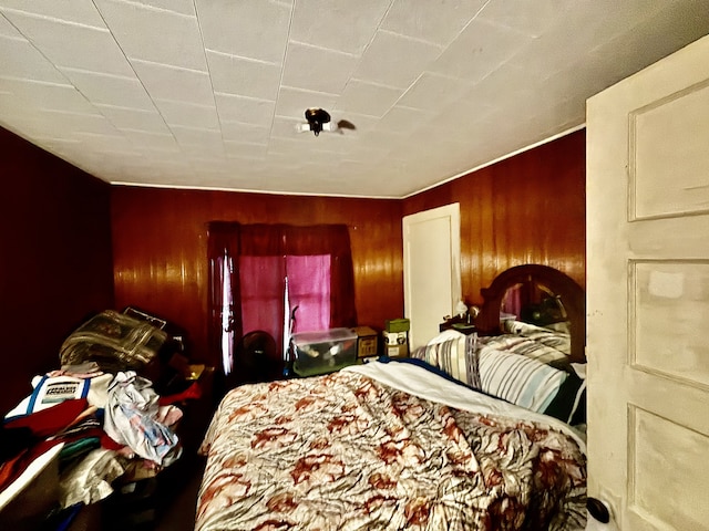 bedroom with wooden walls