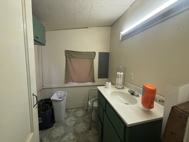 bathroom featuring vanity, electric panel, and a textured ceiling