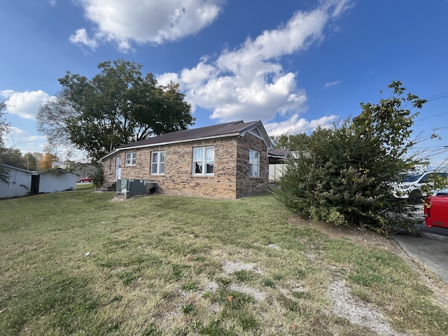 view of side of home with a lawn