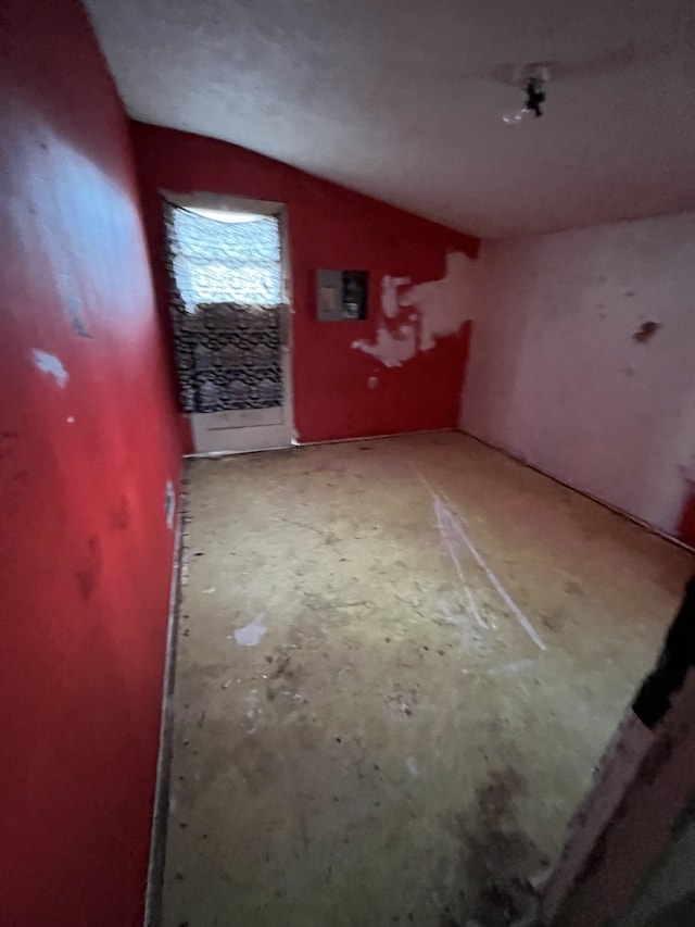 unfurnished room featuring vaulted ceiling