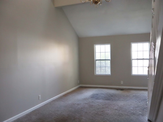 unfurnished room with carpet floors and vaulted ceiling