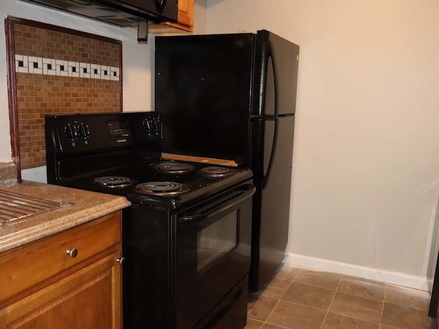 kitchen with tile patterned flooring, backsplash, and black electric range