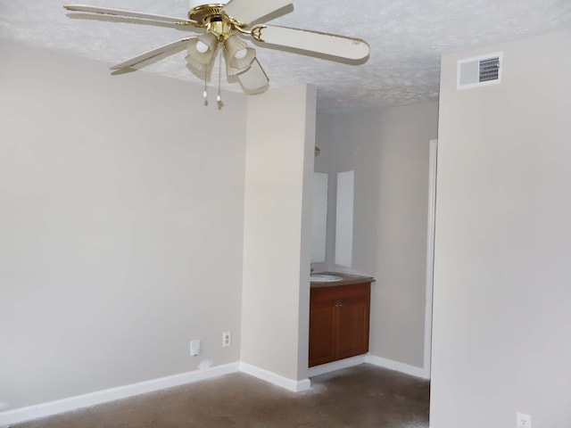 spare room featuring sink, a textured ceiling, and ceiling fan