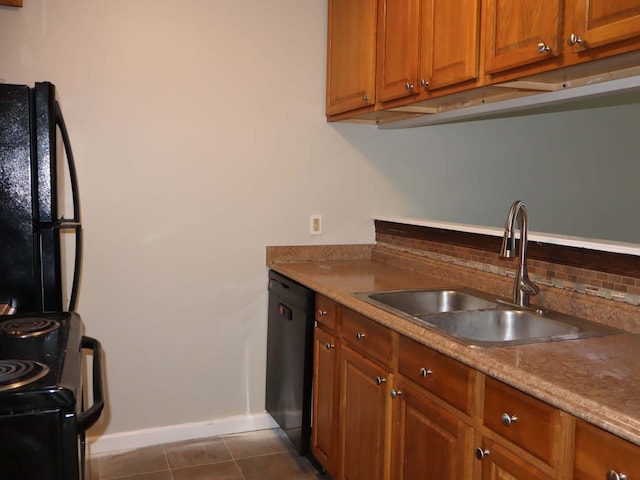 kitchen featuring dark tile patterned flooring, black appliances, and sink