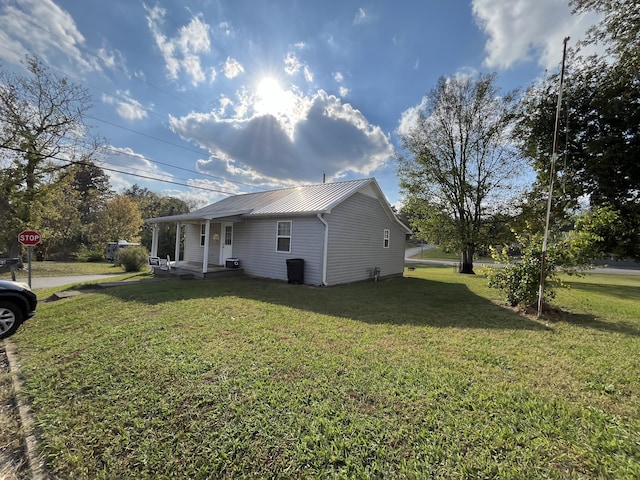 view of side of home with a lawn