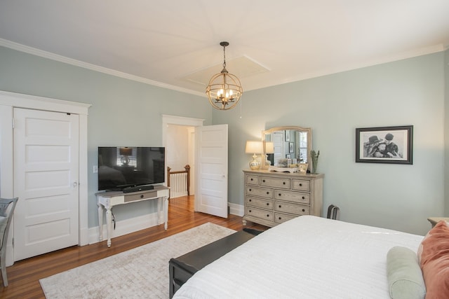 bedroom featuring wood-type flooring, an inviting chandelier, and ornamental molding