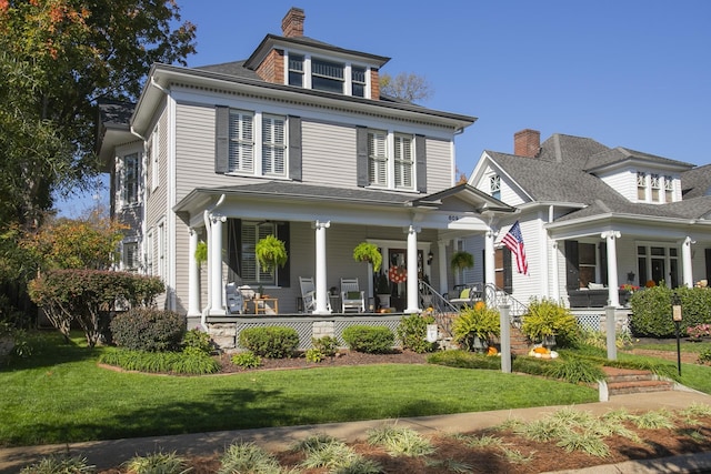 view of front of house with a front lawn and a porch