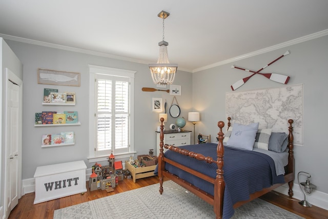 bedroom featuring a chandelier, ornamental molding, and hardwood / wood-style flooring