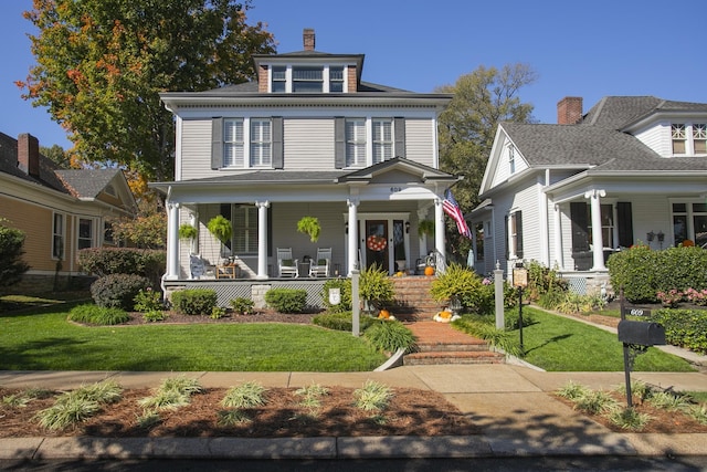 view of front of property featuring a front yard and covered porch