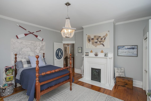 bedroom with hardwood / wood-style flooring, crown molding, and a chandelier