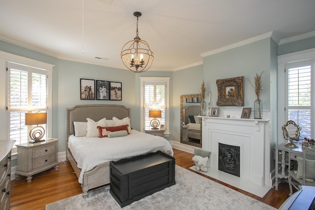 bedroom featuring an inviting chandelier, wood-type flooring, and multiple windows