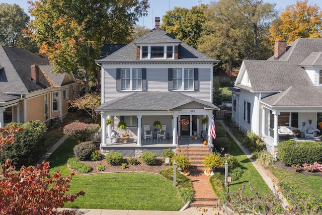 view of front of home featuring covered porch and a front lawn