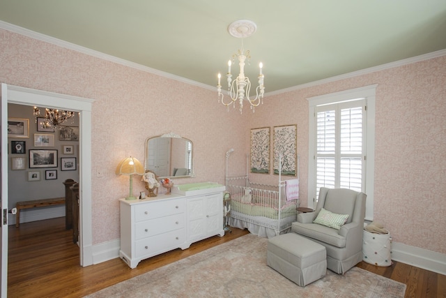 bedroom with a notable chandelier, ornamental molding, and hardwood / wood-style flooring