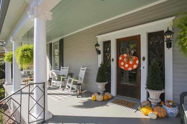 view of exterior entry featuring covered porch