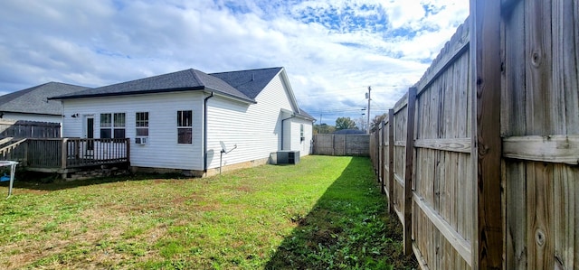 view of home's exterior featuring central AC unit, a yard, and a wooden deck