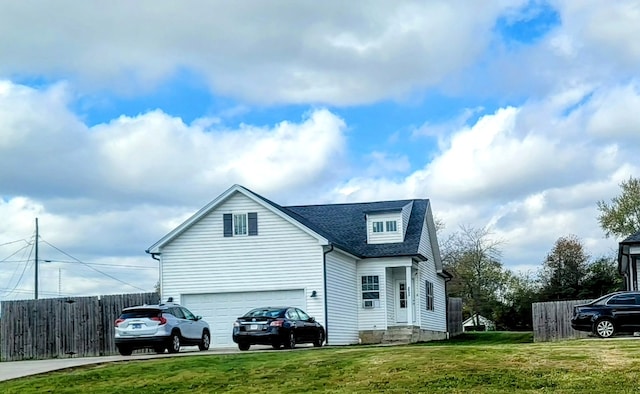 exterior space featuring a garage and a front lawn