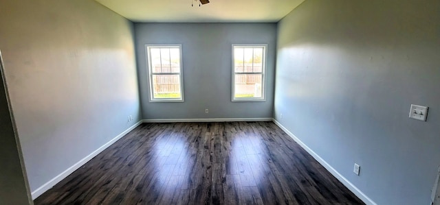 spare room featuring dark hardwood / wood-style floors and ceiling fan