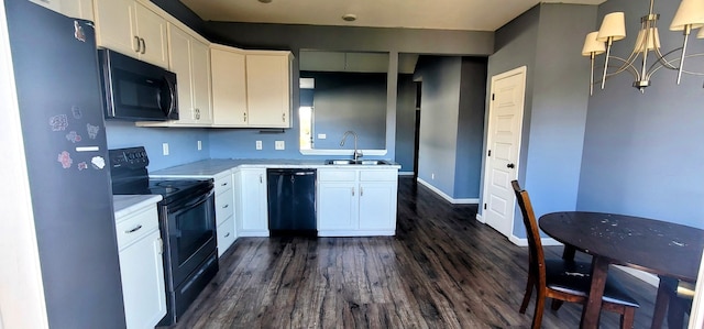 kitchen with dark wood-type flooring, sink, black appliances, decorative light fixtures, and white cabinetry