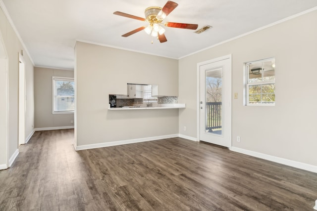 unfurnished living room featuring crown molding, ceiling fan, and dark hardwood / wood-style flooring