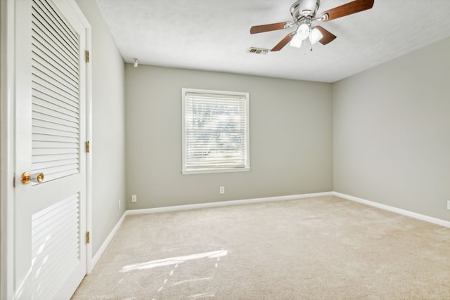 unfurnished bedroom featuring ceiling fan and light colored carpet