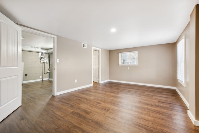 unfurnished room with dark hardwood / wood-style flooring