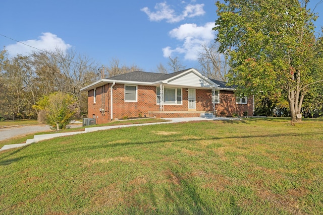 view of front of home featuring central AC and a front lawn