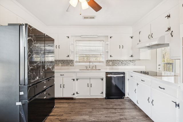 kitchen with white cabinets, black appliances, sink, and dark hardwood / wood-style flooring