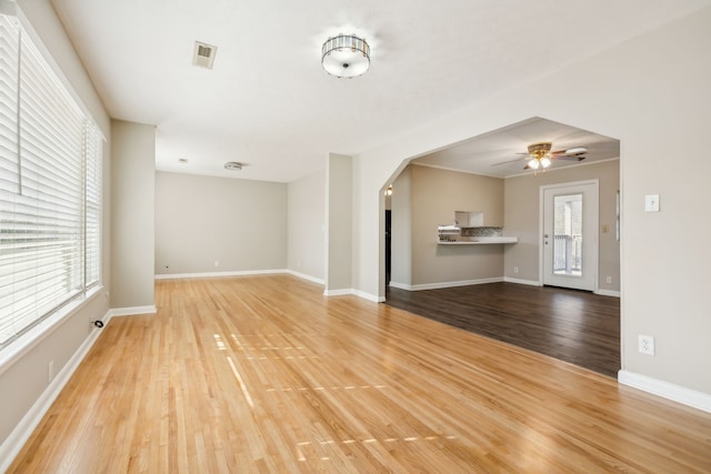 unfurnished living room featuring light hardwood / wood-style flooring, a healthy amount of sunlight, and ceiling fan