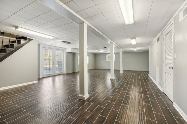 basement featuring french doors and dark hardwood / wood-style floors