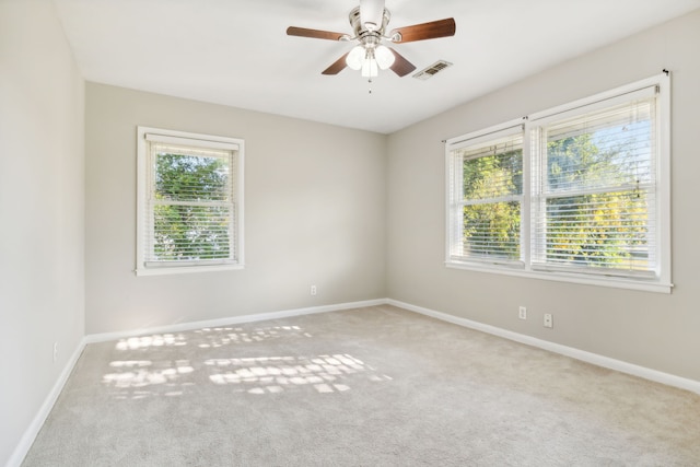 empty room featuring ceiling fan and carpet flooring